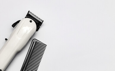 Hairdressing and barber tools. Professional comb and hairdressing clipper. The concept of hair care and professional grooming. Copy space for marketing materials, banners and social networks.