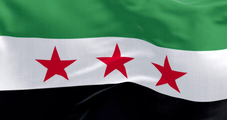 Syrian opposition flag waving close-up with three red stars on fabric