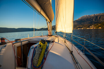 Sunlit sail of a sailing yacht in the wind sailing on Adriatic sea in Montenegro