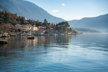 Naklejka premium View of small village on coastline of Gulf of Kotor Bay next to Kotor town in Montenegro