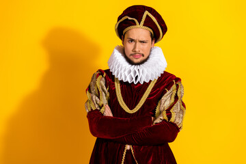 Young man dressed as a nobleman in a vintage costume against a yellow backdrop combining historical...
