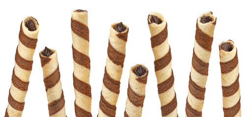 Waffle rolls, striped chocolate and vanilla wafer sticks isolated on white background, full depth of field