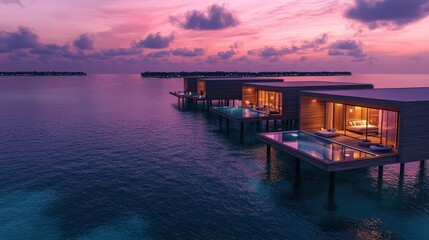 Fototapeta premium Stunning overwater villas at sunset, reflecting serene ocean views and vibrant skies.