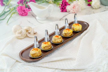 Grilled button mushrooms on a simple background