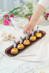 Grilled button mushrooms on a simple background