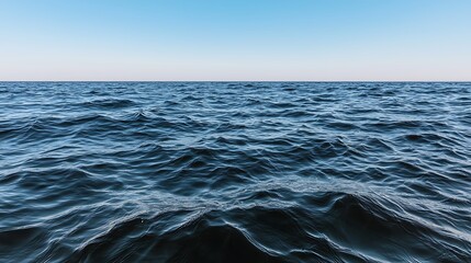 Fototapeta premium Calm Ocean Waves Under Clear Blue Sky with Horizon View and Gentle Ripples for Nature Lovers