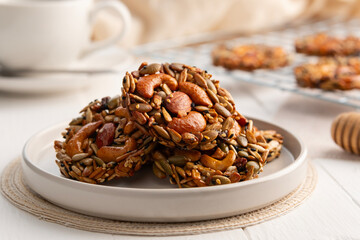 whole grain cookies no flour no sugar in a plate.Mixed nuts, Almonds, Cashews, Peanuts, Raisins, sesame, sunflower, watermelon seed with honey cookie.