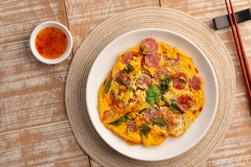 Fermented Pork Omelet, Thai Omelette with Fermented sour pork in white plate.Top view.