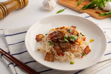 Stir Fried Rice Vermicelli with Bacon chilli and Holy Basil Seasoning in white plate.