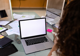 Fototapeta premium Woman working on laptop at home office with documents and sticky notes, copy space