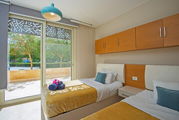 Interior design of bedroom in house with garden view