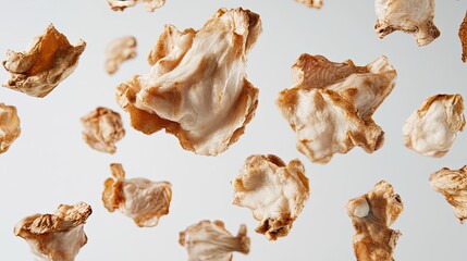 Fototapeta premium Boneless chicken breast pieces suspended gracefully against a pristine white backdrop.