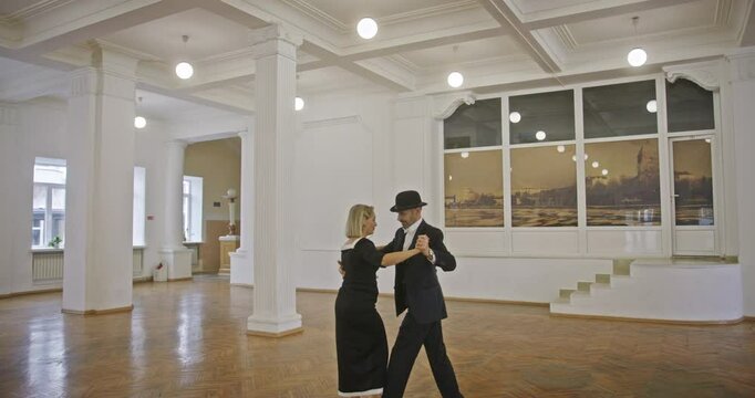 Mature Couple Performing Elegant Dance in a Classic Ballroom