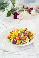 Mixed fruit and vegetable salad on a simple background