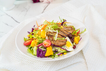 Mixed fruit and vegetable salad on a simple background