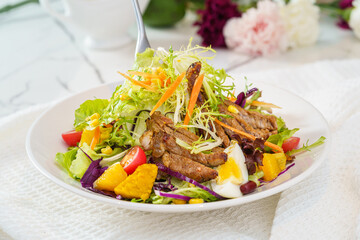 Mixed fruit and vegetable salad on a simple background