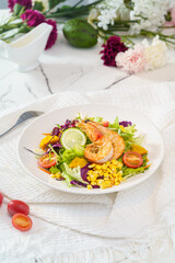Mixed fruit and vegetable salad on a simple background