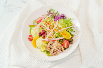 Mixed fruit and vegetable salad on a simple background