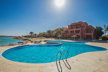 Outdoor swimming pool in a luxury tropical apartment resort