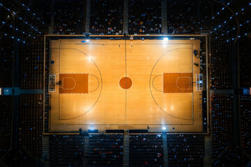 Aerial view of an illuminated basketball court during a game  