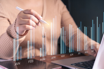 A business professional analysis financial growth using digital data visualization.Bar chart overlay with monthly performance trends, financial forecasting, and market insights.