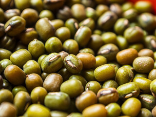 Mung beans on a light background, emphasizing their shape and texture, create a feeling of freshness and naturalness.