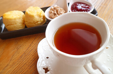 Closeup of a Cups of Hot Tea with Plate of Scones in the Backdrop