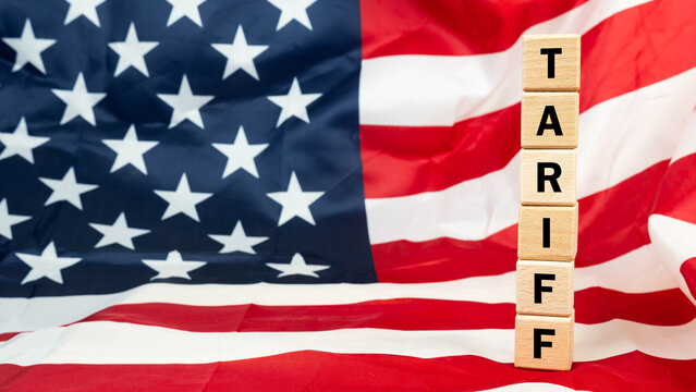 Wood cube tariffs aword on Flag of the United States of America background.
Tariff USA trade war with Canada and Mexico.