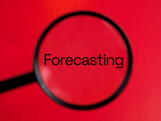 forecasting text through magnifying glass red background