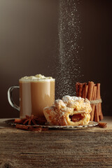 Vienna strudel and caffe latte on an old wooden table.