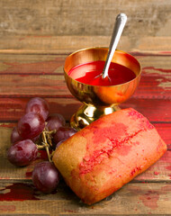 cup with wine and bread. Concept of the flesh and blood of Jesus Christ
