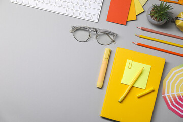 Designer's workplace. Flat lay composition with stationery and keyboard on light grey background,...