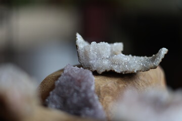 Macro Shot of Raw Quartz Crystal on Wooden Base