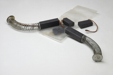 DC motor contact carbon brushes, with copper wire shunt, kit with push spring, spare element, expendable parts of electric motors, brand new elements, transparent plastic bag. closeup