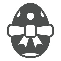 Easter egg with bow solid icon, easter holiday concept. Vector graphics. Festive egg with pattern and ribbon sign on white background, glyph style icon for mobile or web design.