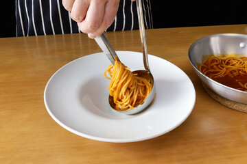 How to serve pasta beautifully using tweezers and a ladle. Italian cuisine
