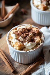 A detailed image of a warm bread pudding served in a ramekin, topped with a creamy bourbon sauce and a sprinkle of cinnamon