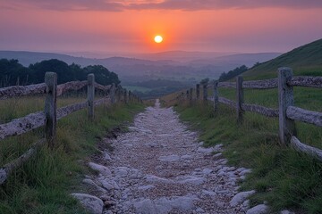 Fototapeta premium Sunrise path through valley with wooden fence