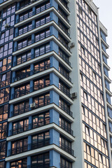 A very tall building featuring numerous windows and balconies throughout it