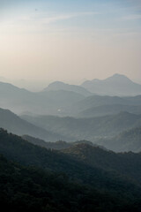 view over a foggy mountain landscape in Ella, sri lanka early in the morning at sunrise