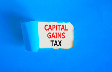 Capital gains tax symbol. Concept words Capital gains tax on beautiful white paper. Beautiful blue paper background. Business and capital gains tax concept. Copy space.