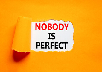 Naklejka premium Nobody is perfect symbol. Concept words Nobody is perfect on beautiful white paper. Beautiful orange paper background. Business motivational lifestyle and nobody is perfect concept. Copy space.