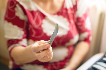 A skilled woman with a sharp knife in a wellequipped kitchen, ready to prepare a delicious meal