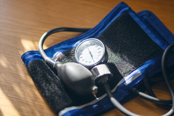 A sphygmomanometer, used to measure blood pressure, with a cuff is placed on the table