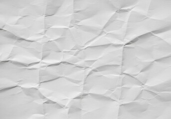 Fototapeta premium Crumpled White Paper Texture - Close-up shot of a crumpled piece of white paper, showing texture and creases. Ideal for backgrounds or design elements