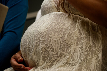 Close up photo of a pregnant woman in a dress