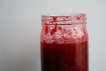 A close-up shot of a jam jar on a table.