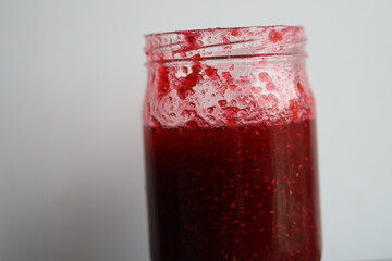 A close-up shot of a jar of jam on a table, suitable for use in food-related contexts.