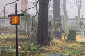 Greek Orthodox cemetery. Abandoned, overgrown, ruined cemetery in the fog. Crumbling tombstones, gravestones without names or surnames. Resting place of the dead