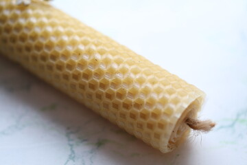 A detailed view of a single ear of corn sitting on a flat surface.